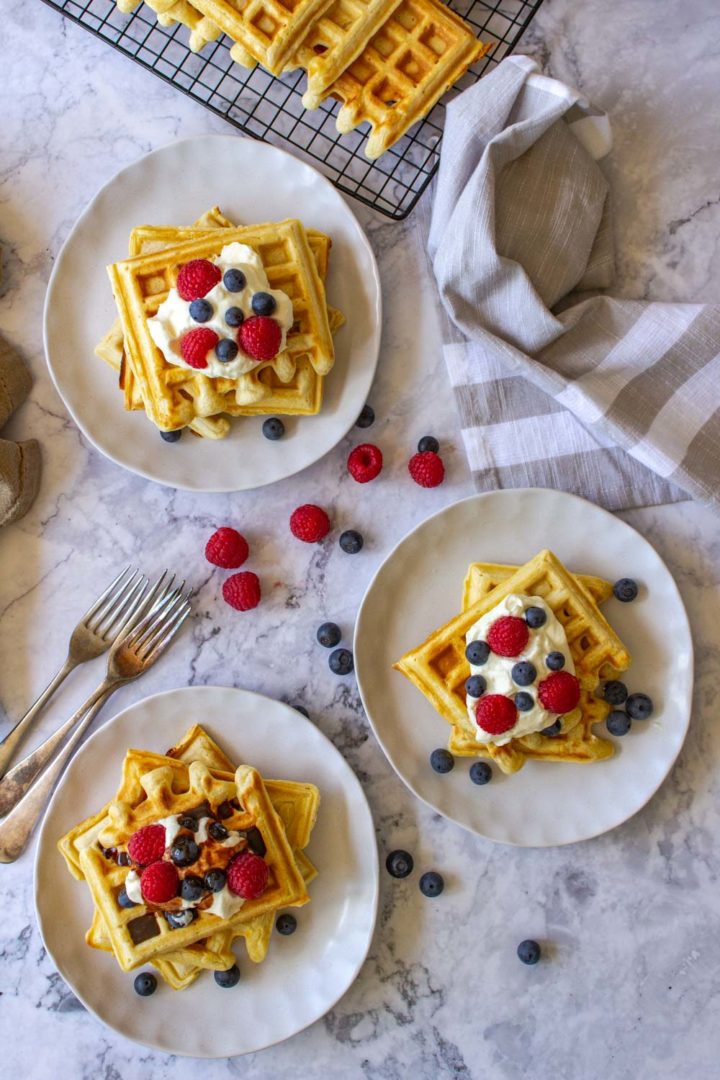 Waffles topped with cream and berries