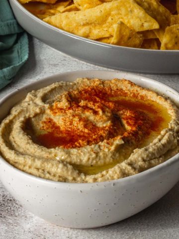 Bowl of Hummus sprinkled with paprika.