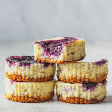 Mini Blueberry Cheesecakes Stacked on each other.