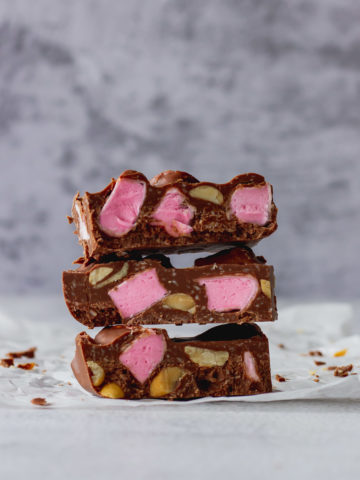 Chocolate Fish Rocky Road stacked on each other 3 high to show pink marshmallow and peanuts.
