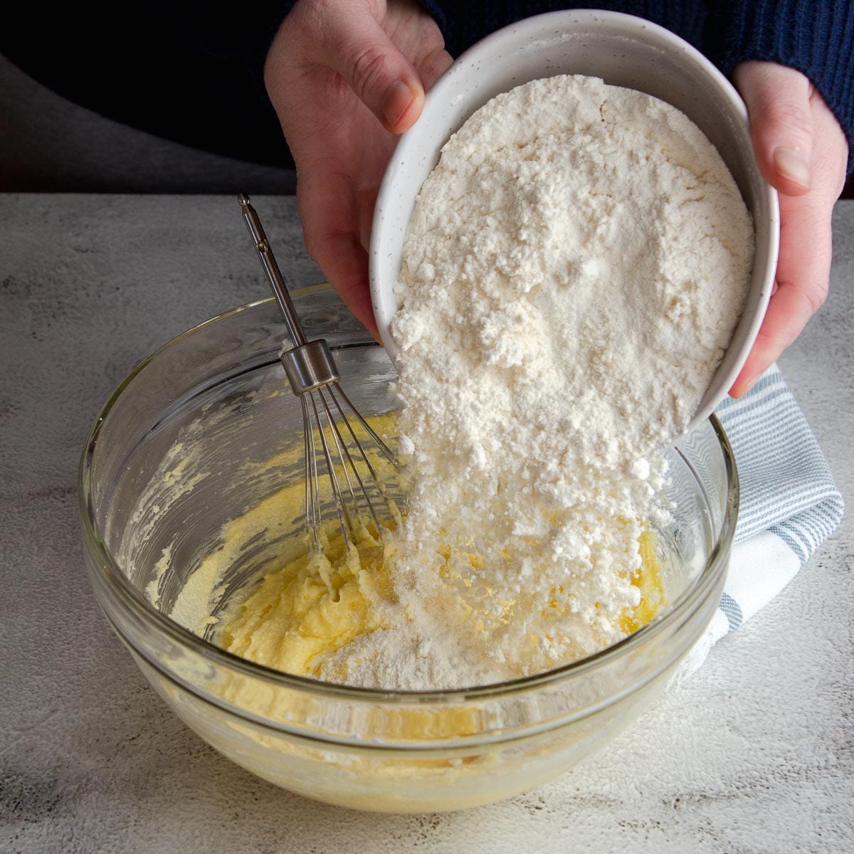 Adding flour to the whipped butter