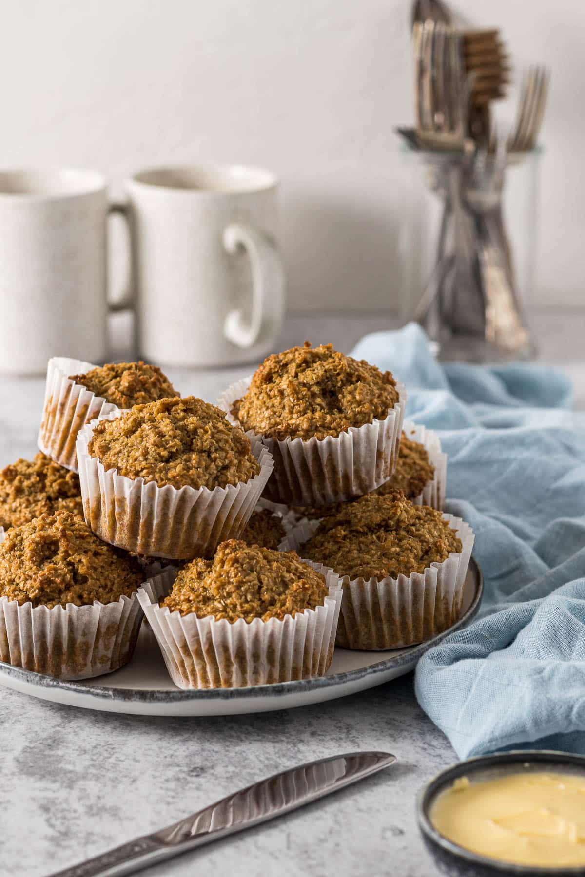 Bran muffins piled on a plate.