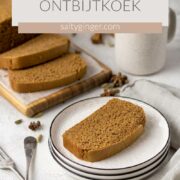 Sliced ontbitjkoek on plates with a cup of coffee.