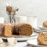 Sliced orange gingerbread cake with an spiced orange glaze showing the cake crumb.