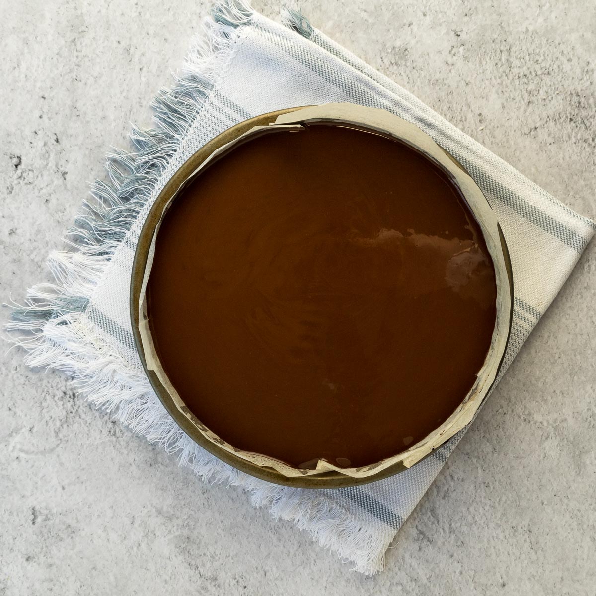 Chocolate topping poured over the caramel