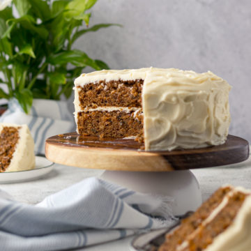 Sliced carrot cake on stand.