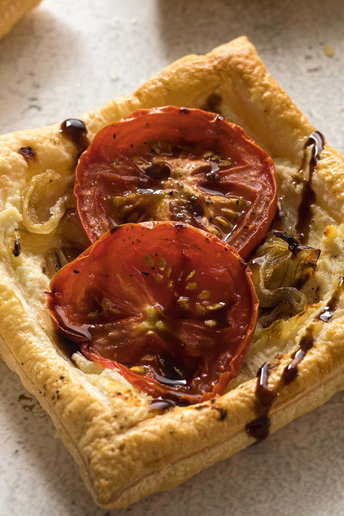 Close up view of the tomato, onion and ricotta mini tarts