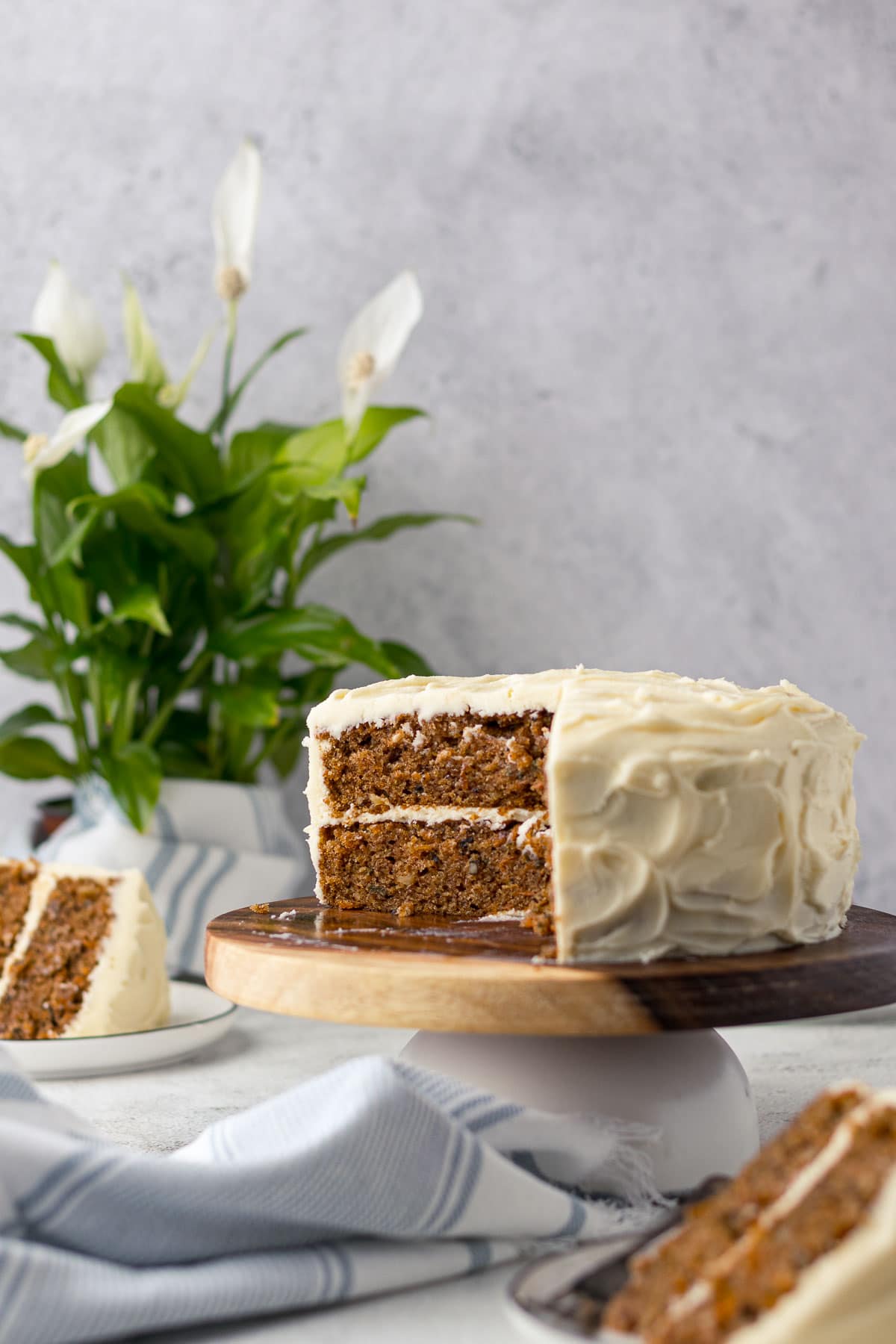 Sliced carrot cake on stand.