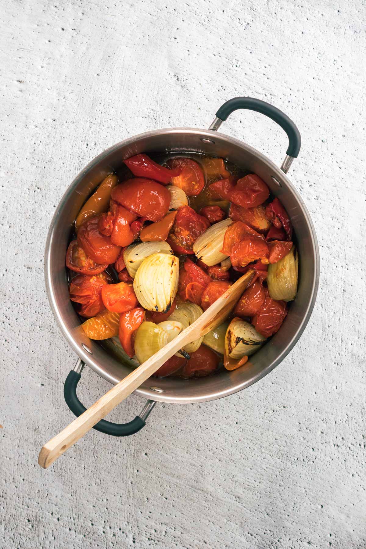 Roasted vegetables in a large pot.