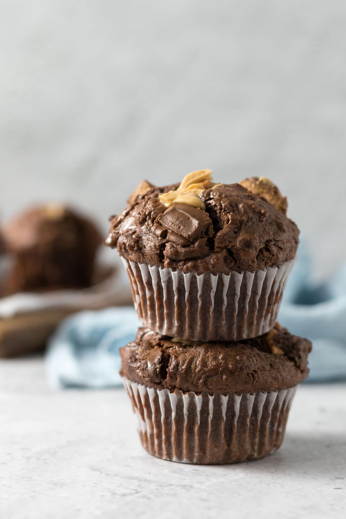 Two chocolate muffins stacked on each other.