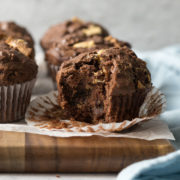 Close up of a triple chocolate muffin with a bite out.