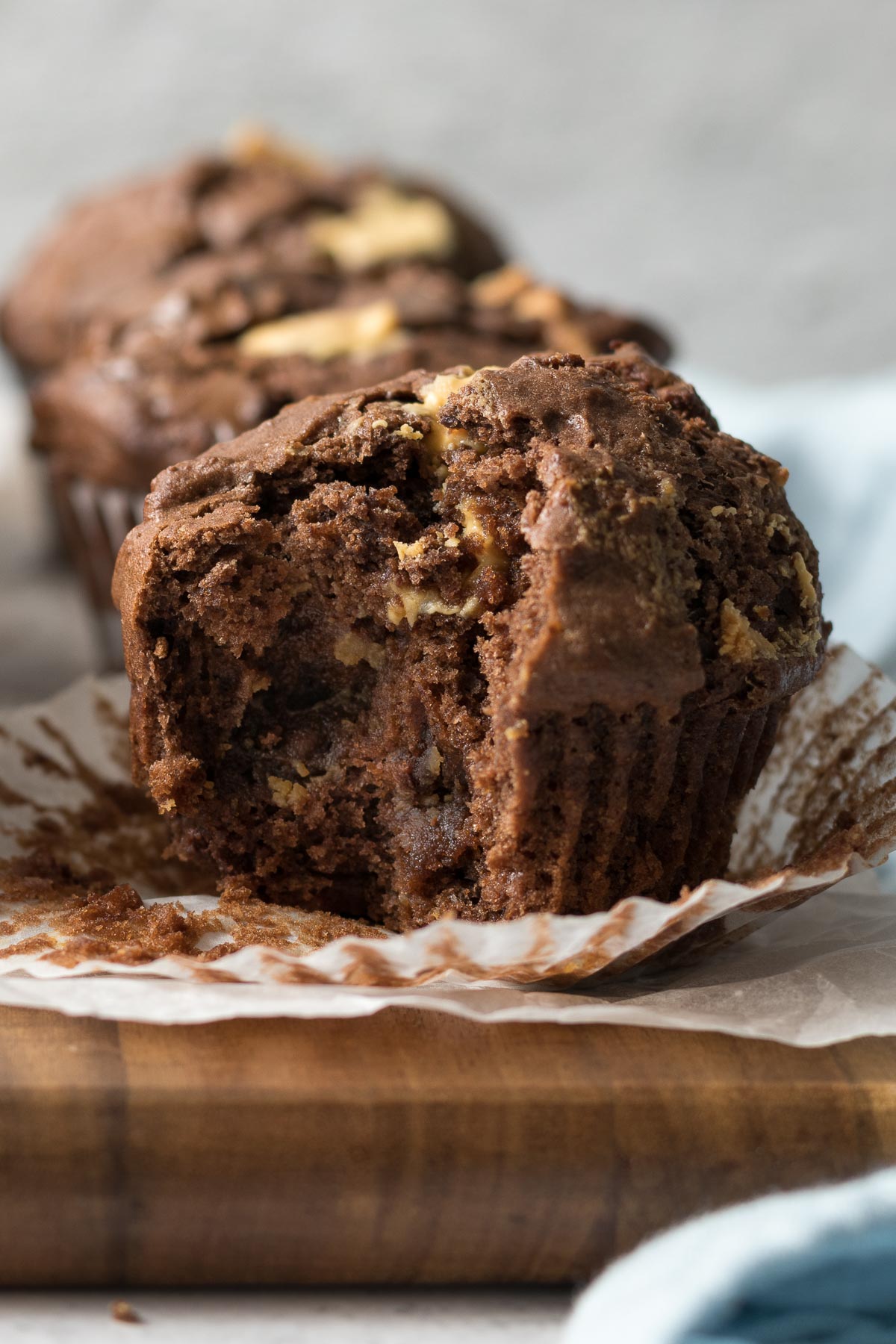 Close up of a triple chocolate muffin with a bite out.