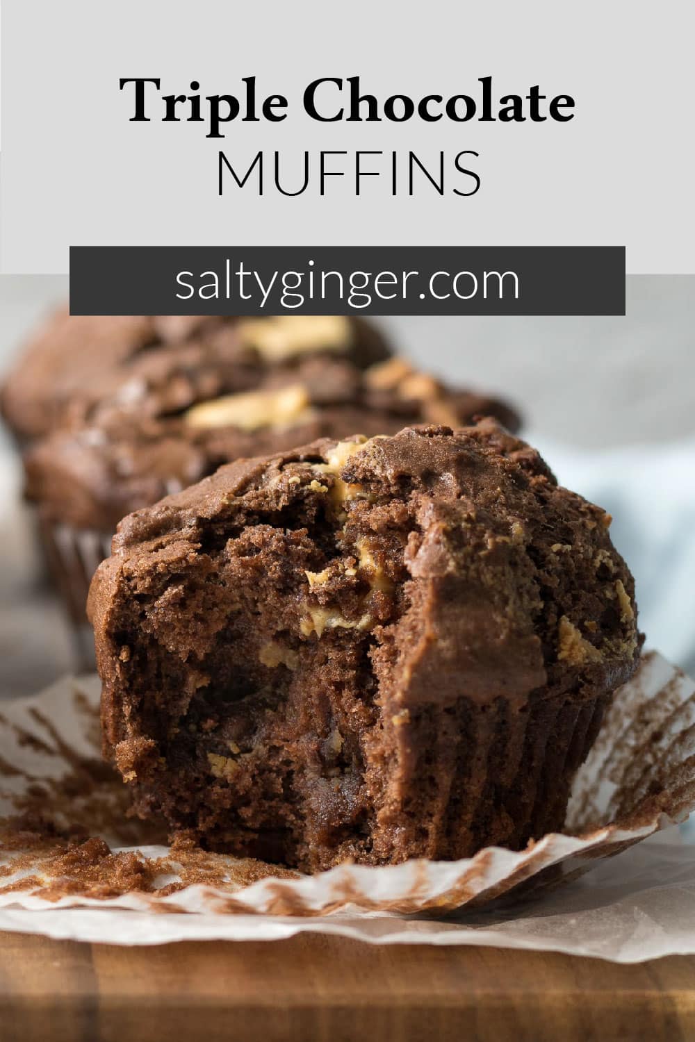 Pin - Triple chocolate muffins with bite out on a platter.