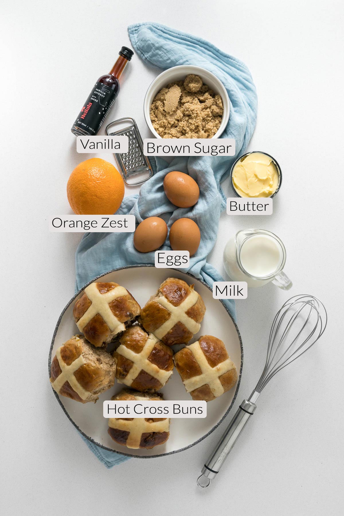 Hot cross bun pudding ingredients - hot cross buns, sugar, orange zest, eggs, butter, milk.