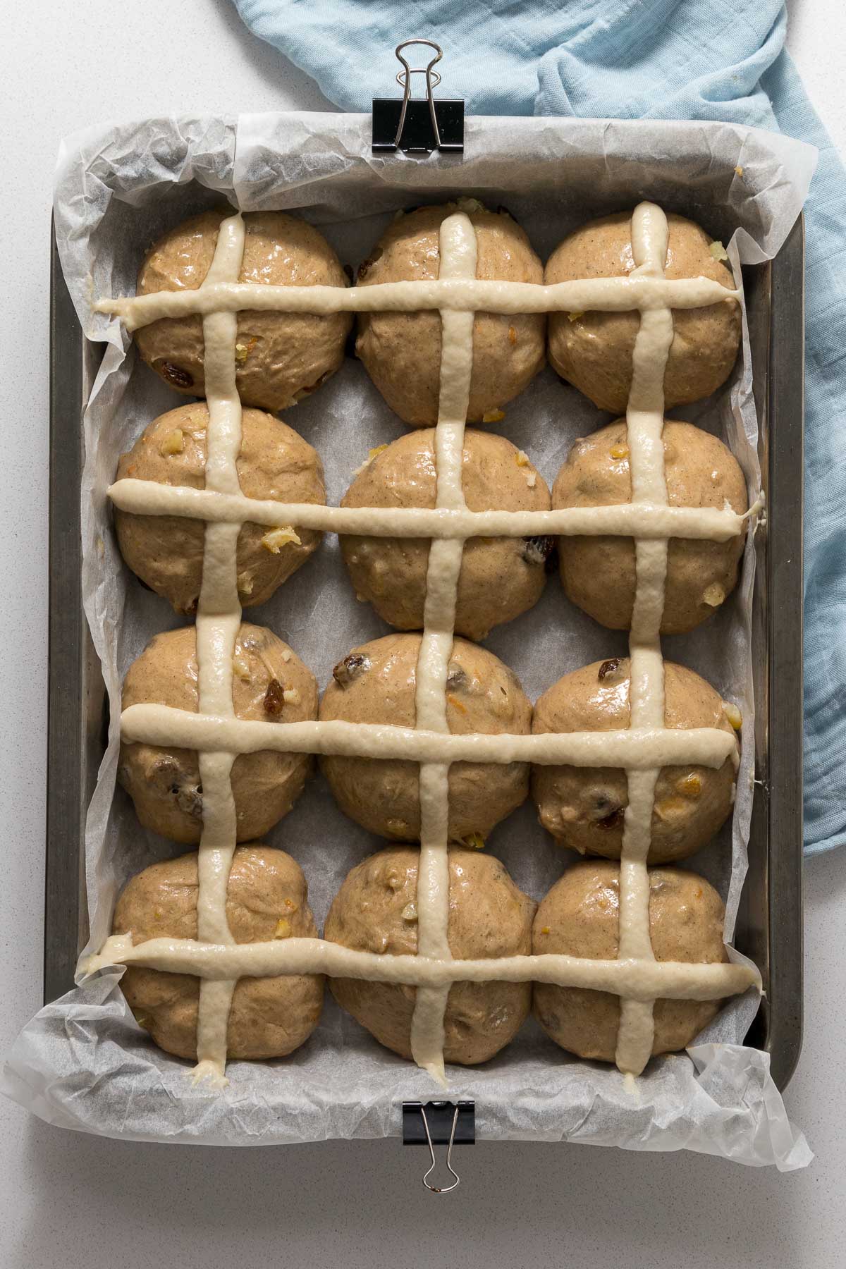 Hot cross bun dough with crosses ready for baking.