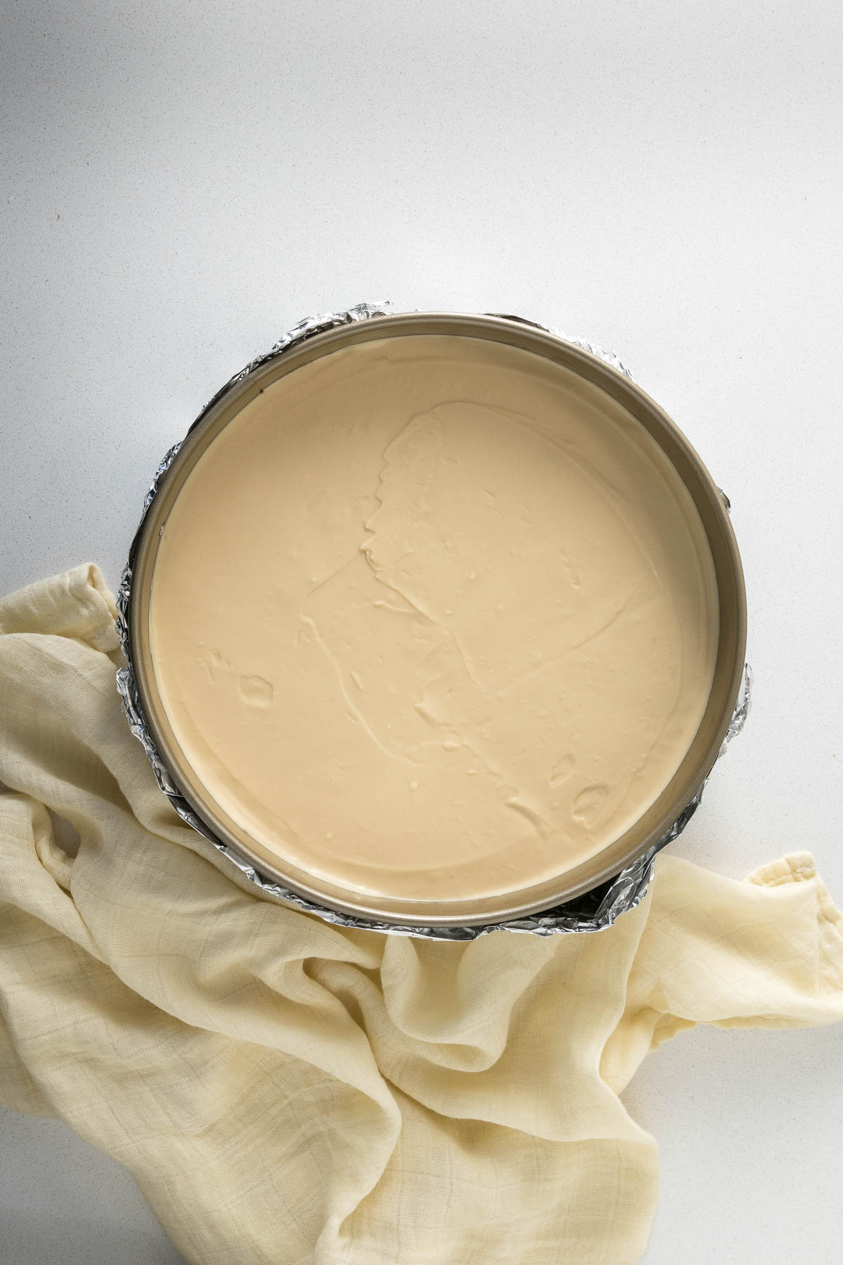 Step 10 - Cheesecake filling smoothed into springform tin.