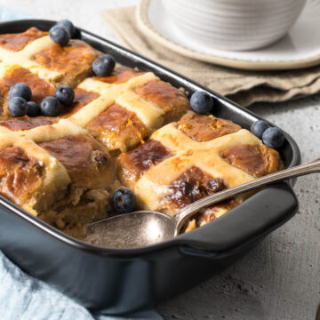 Hot cross bread and butter pudding in a casserole dish.