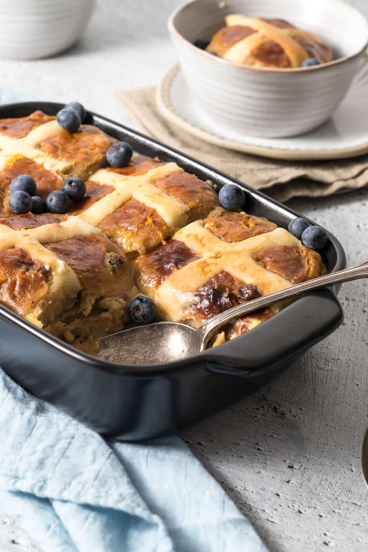 Hot cross bread and butter pudding in a casserole dish.