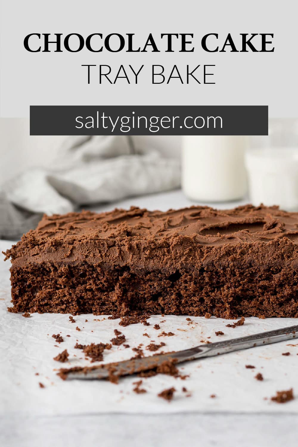 Sliced chocolate tray bake showing milk chocolate ganache.
