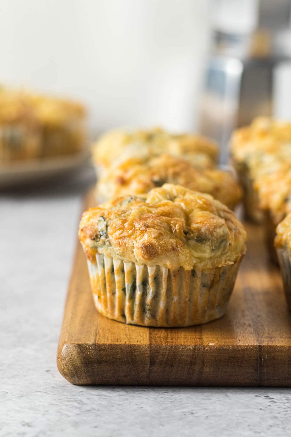 Feta and spinach muffins on a wooden board.