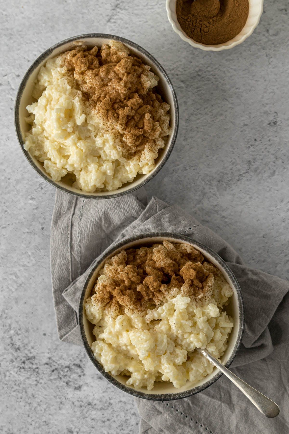Bowls of rice pudding with sprinkle of cinnamon.