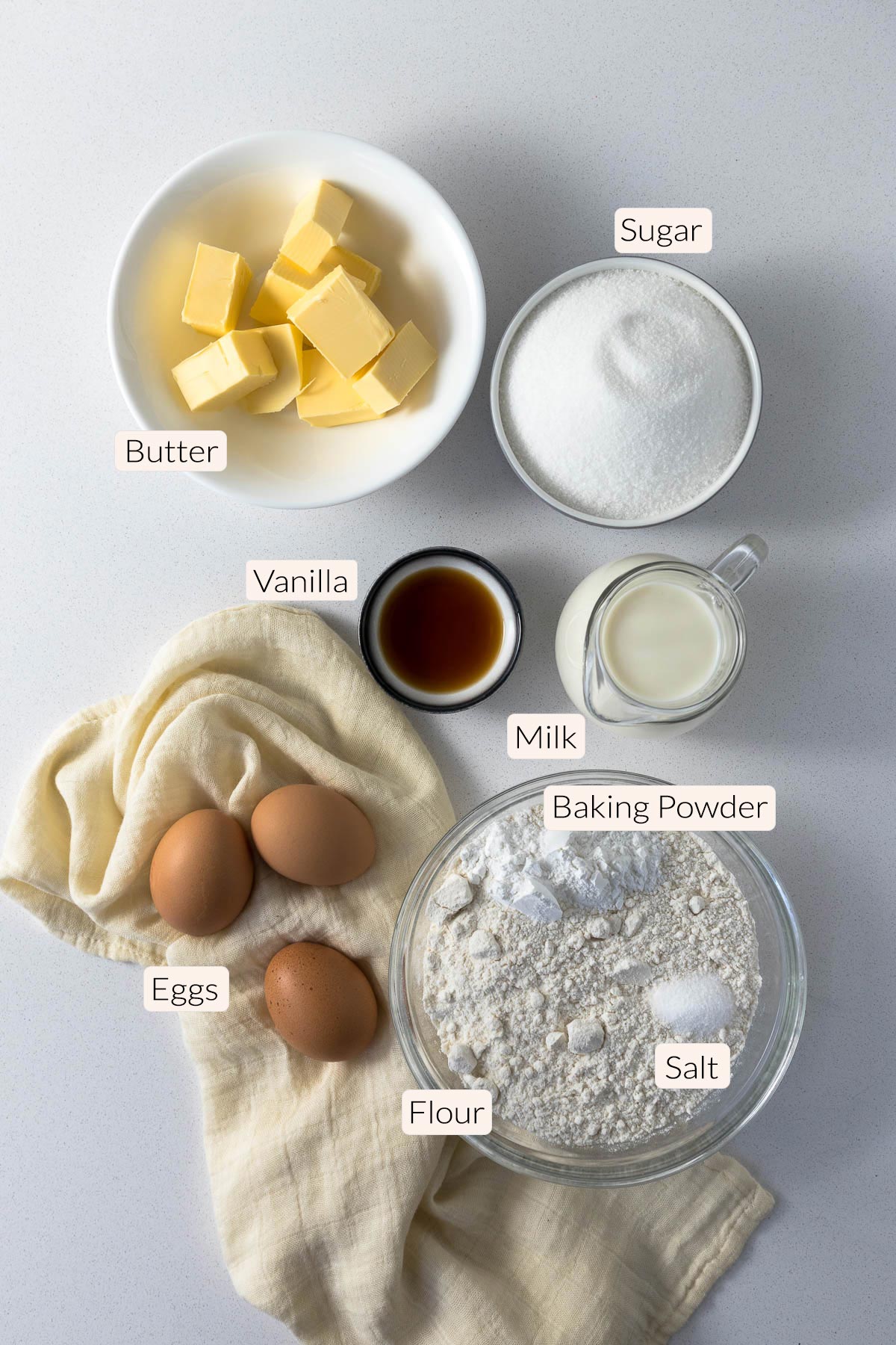 Vanilla traybake ingredients - flour, baking powder, salt, eggs, butter, vanilla, sugar.