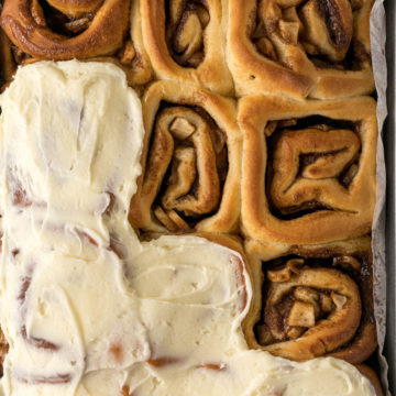 A tray of cinnamon rolls with apple pie filling.