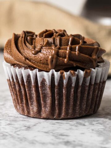 Frosted nutella cupcake with a Nutella drizzle.