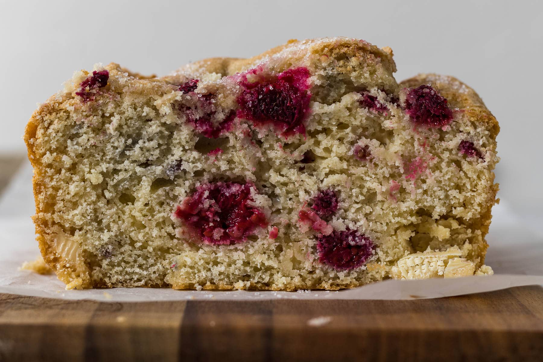 Slice of raspberry and white chocolate loaf cake.