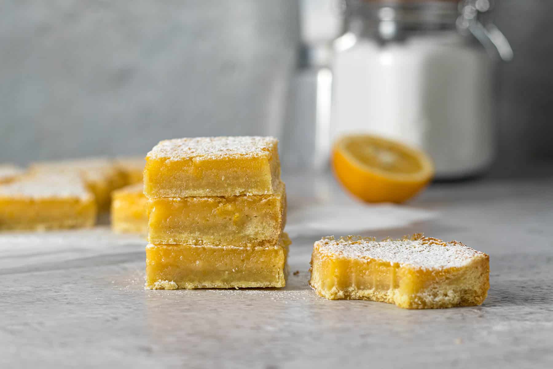 Stack of lemon slices dusted with icing sugar.