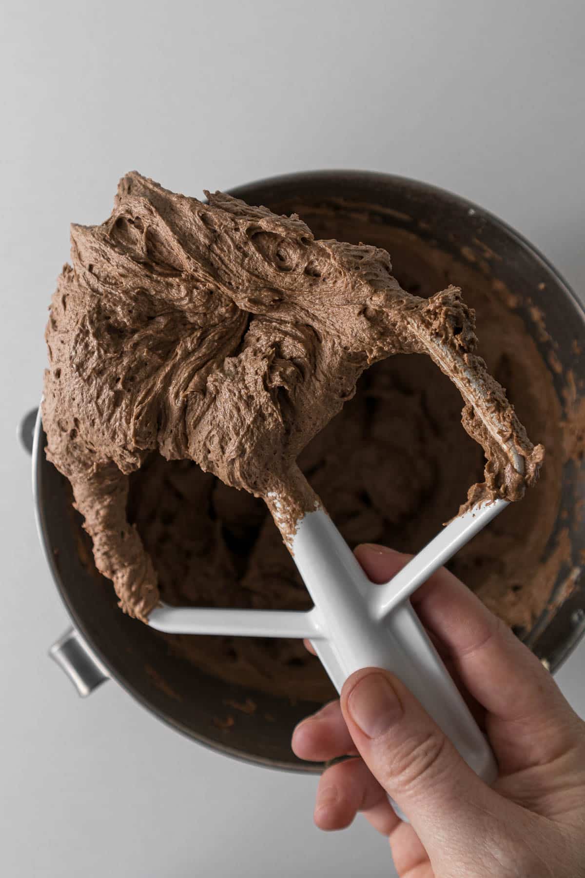 Nutella cream cheese frosting on a mixing paddle.