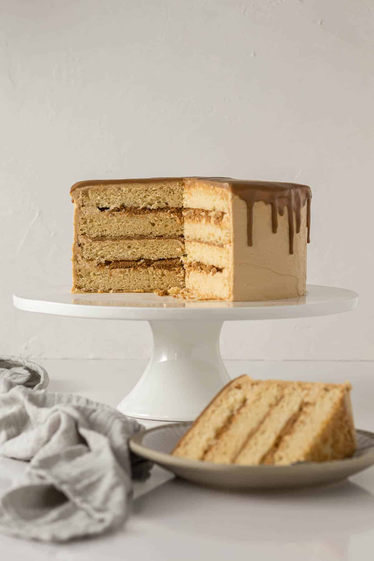 Sliced Biscoff cake on a cake stand.