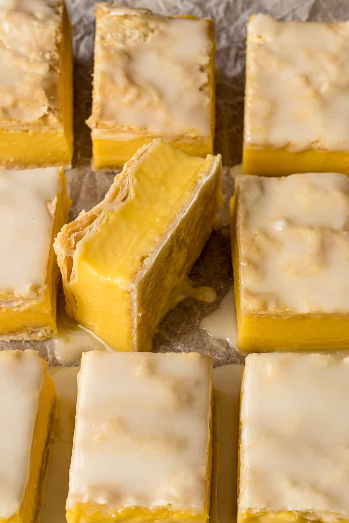 Vanilla slice on its side showing the slayers of pastry and custard.