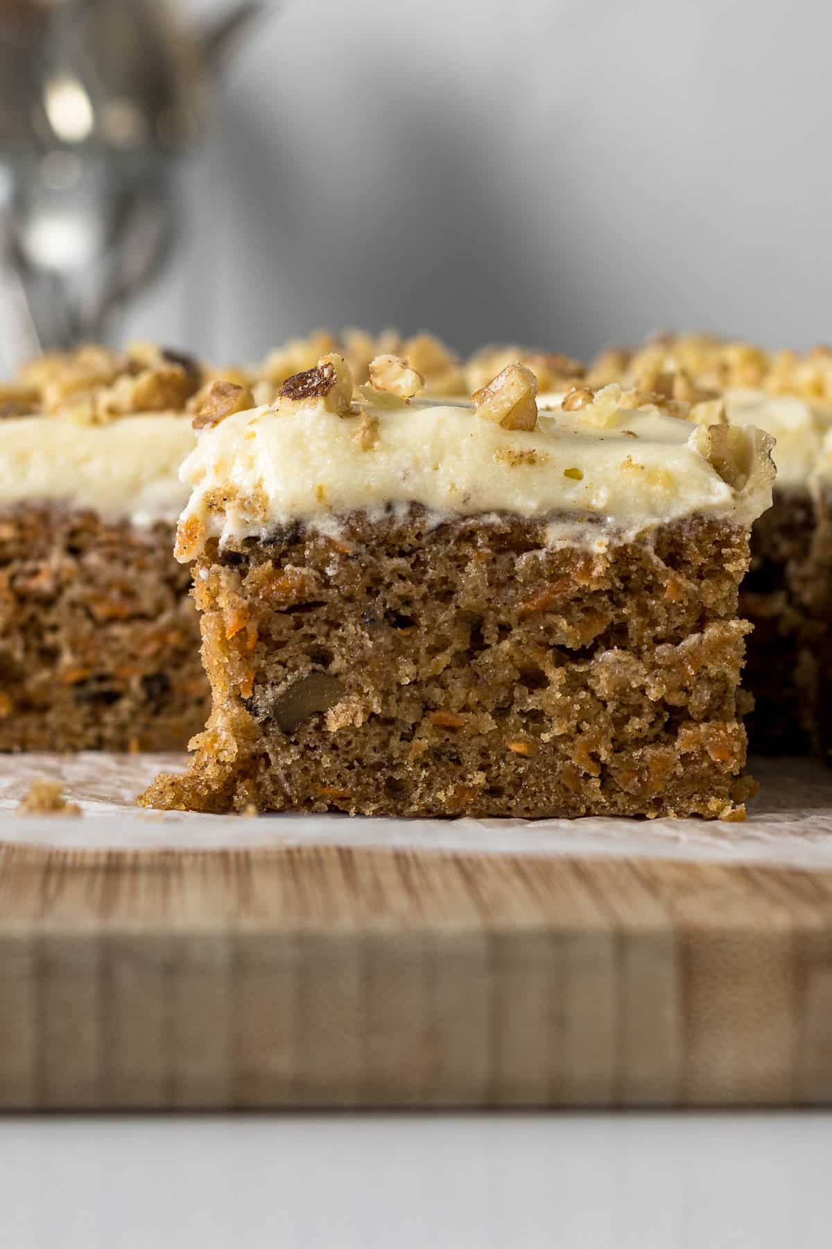 Sliced carrot cake with cream cheese frosting.