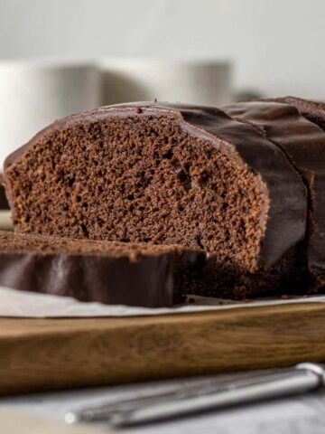 Sliced chocolate loaf cake with chocolate glaze.