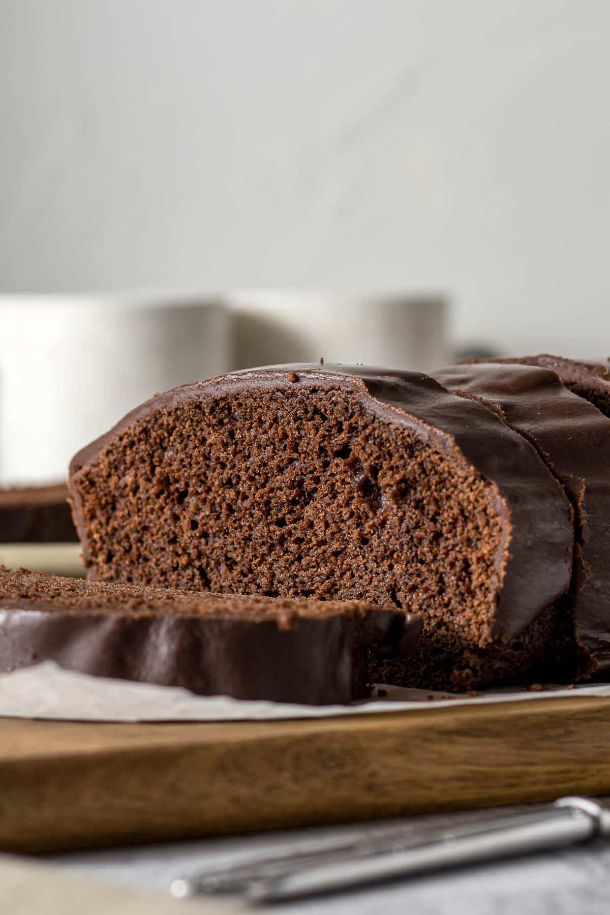 Sliced chocolate loaf cake with chocolate glaze.