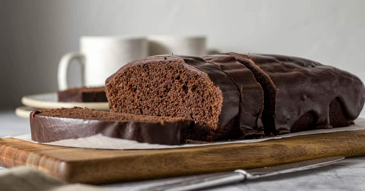 Sliced chocolate loaf cake on a platter.