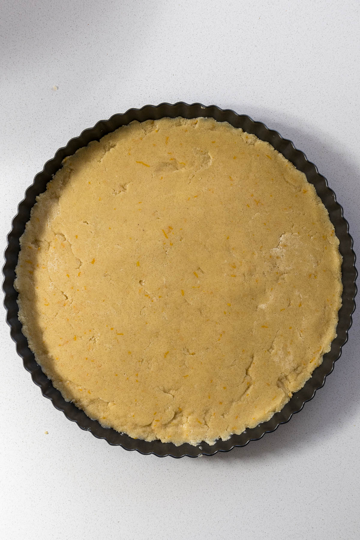 Biscuits pressed into tart tin.