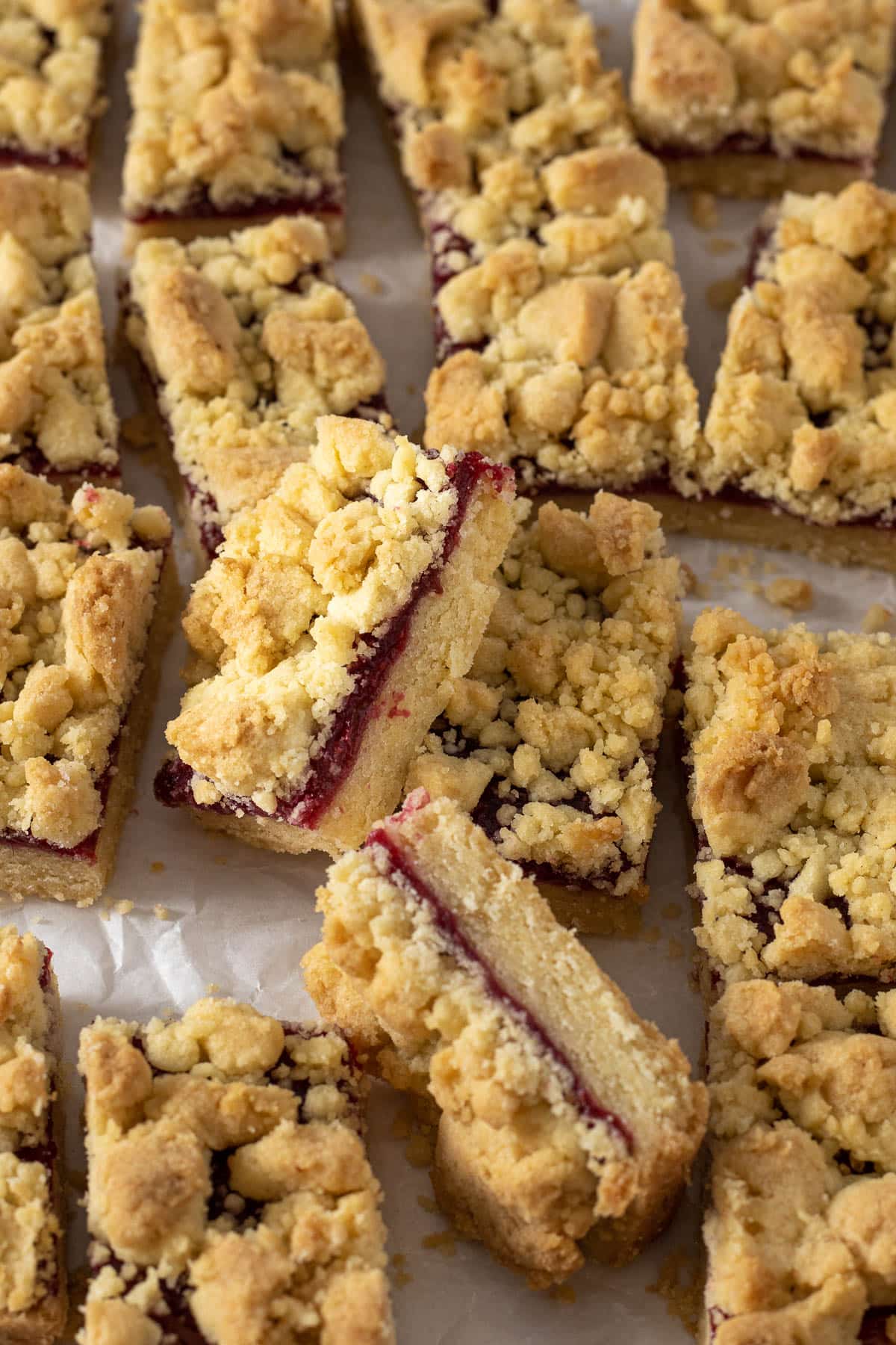 Sliced jam bars on a parchment paper.