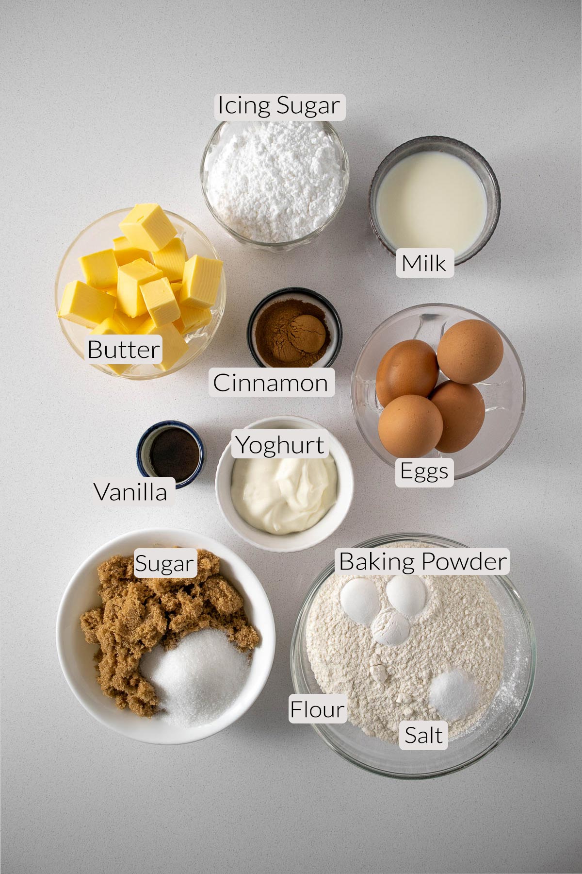 Cinnamon bundt cake ingredients: flour, baking powder, salt, sugar, eggs, milk, yoghurt, cinnamon and vanilla.