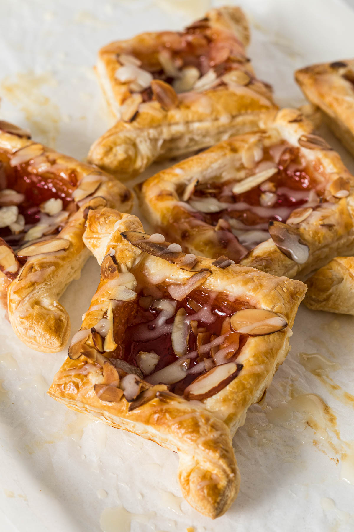 Baked jam puff pastry tarts topped with glaze.