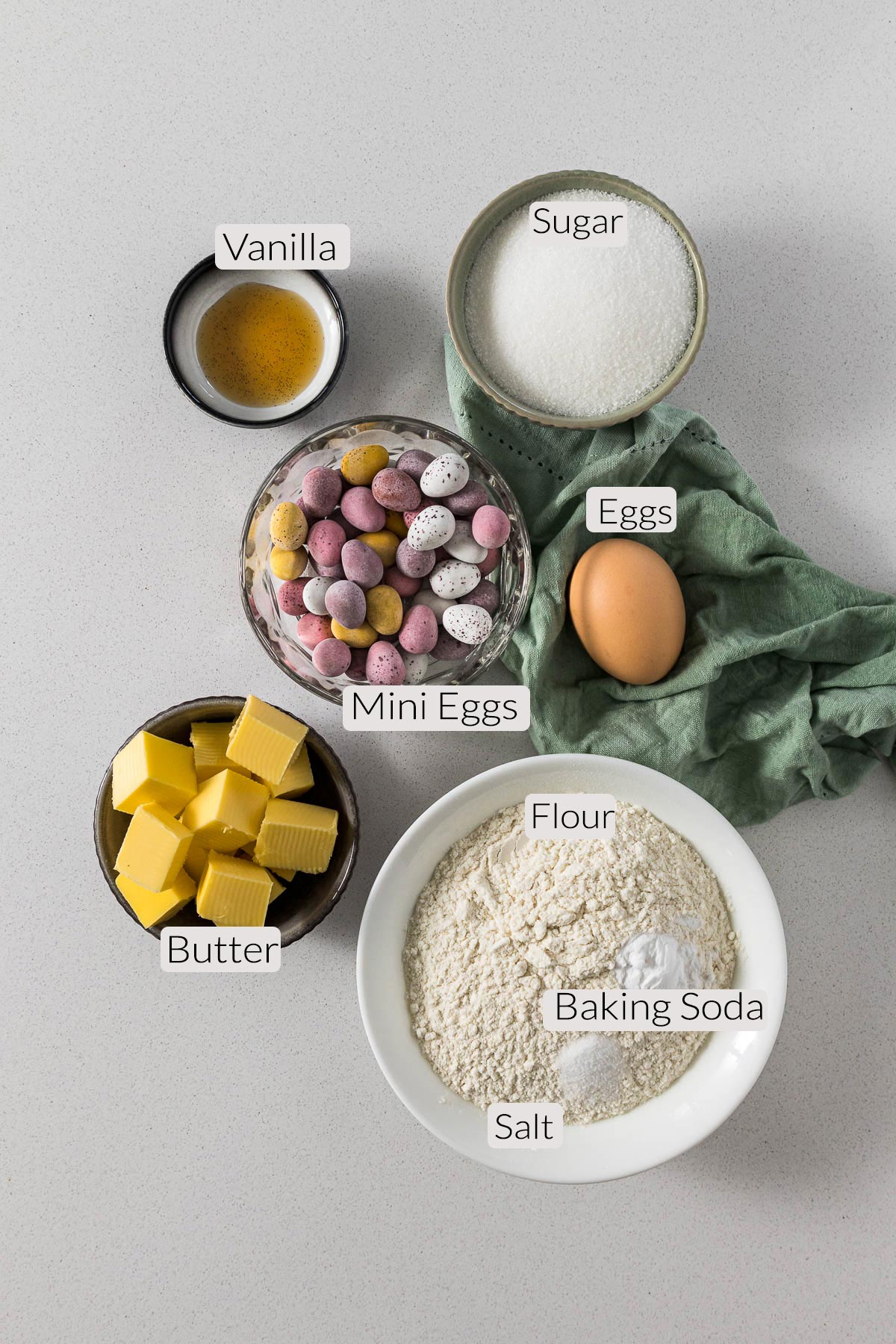 Mini eggs cookies ingredients - vanilla, sugar, mini eggs, eggs, butter, flour, baking soda, salt.