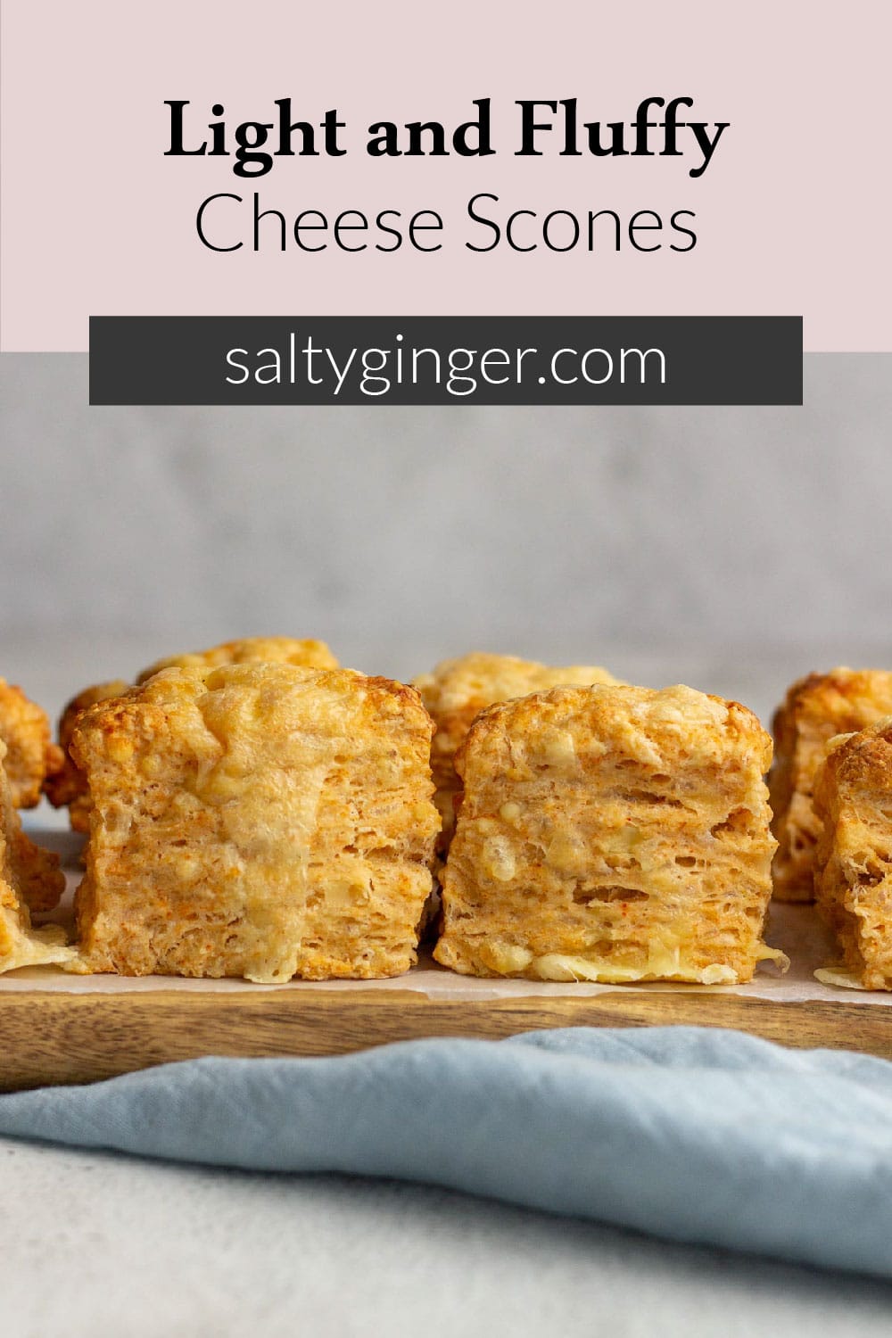 Pin - Light and fluffy cheese scones in a row.