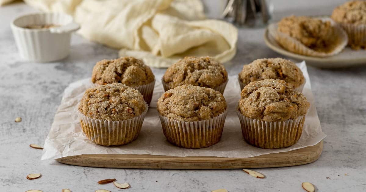 Muffins placed on wooden serving platter.