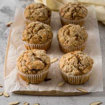 Banana carrot muffins on a serving board.