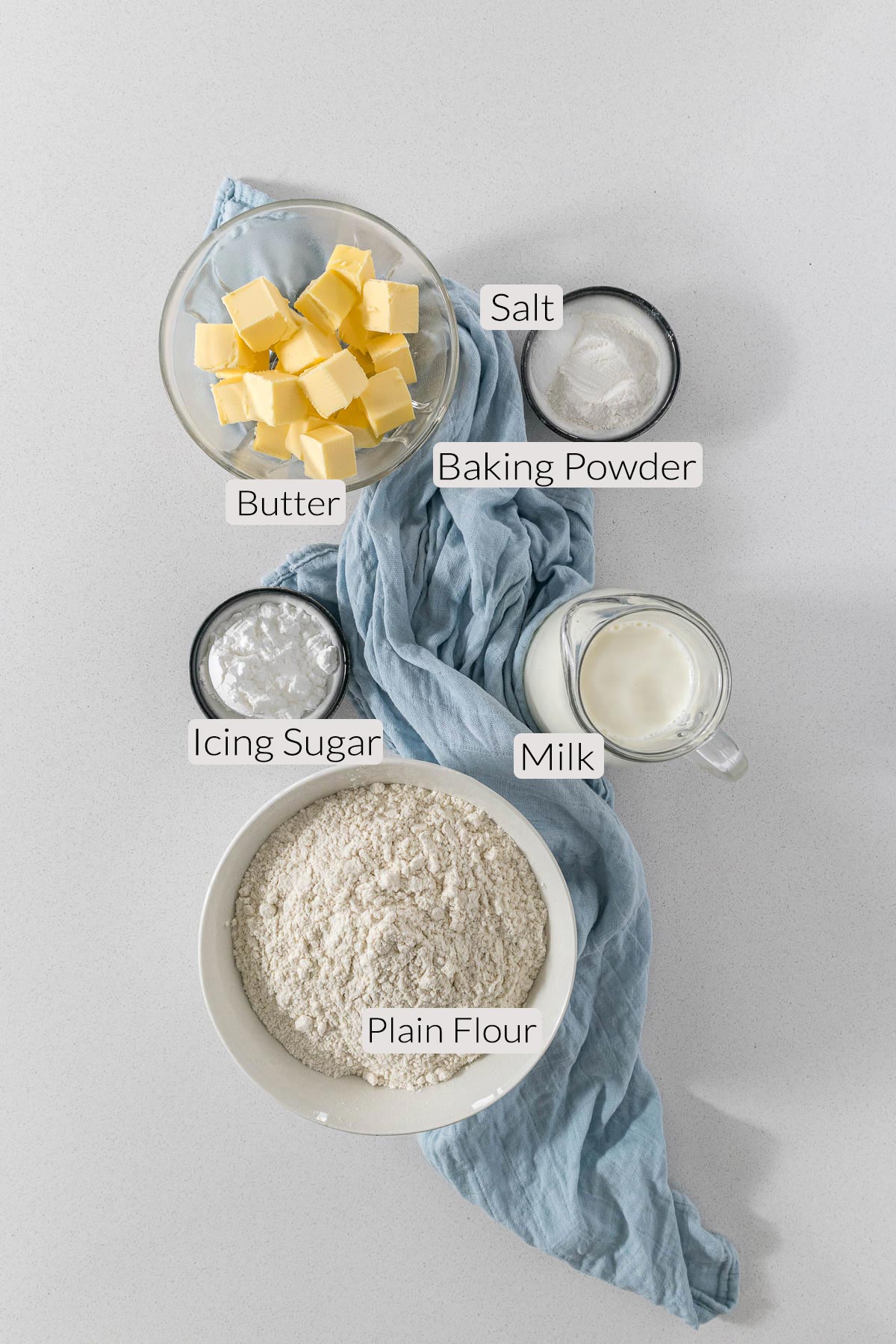Scones ingredients - flour, baking powder, salt, milk, butter, icing sugar.
