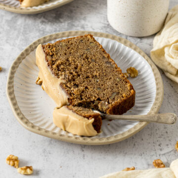 Slice of coffee and walnut loaf on a plate.