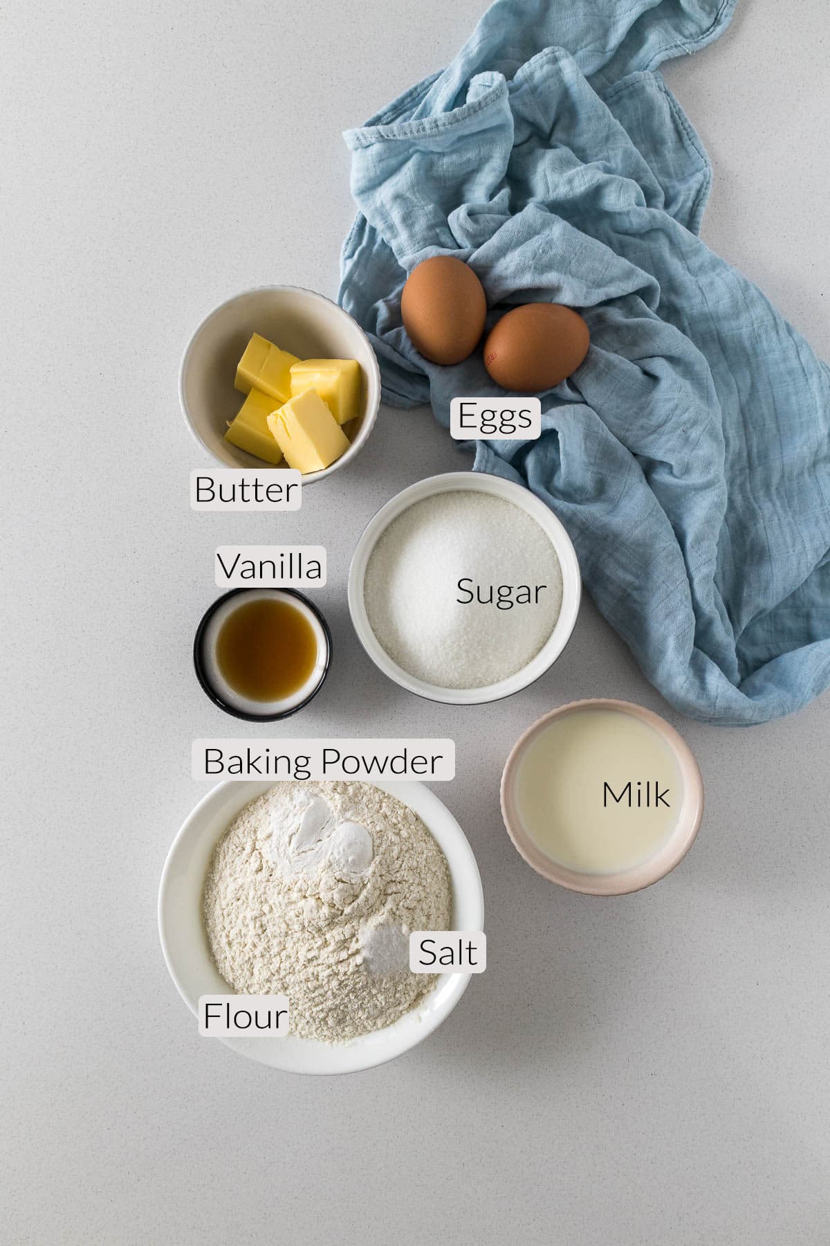 Vanilla cupcake ingredients - flour, baking power, salt, milk, sugar, vanilla, butter, eggs.