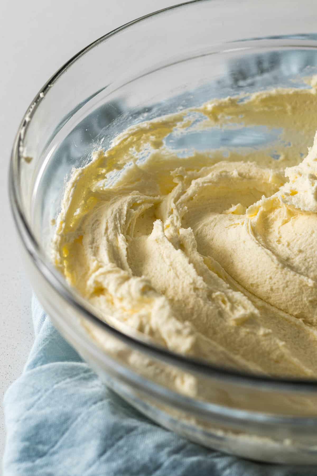 Whipped buttercream frosting in a large mixing bowl.