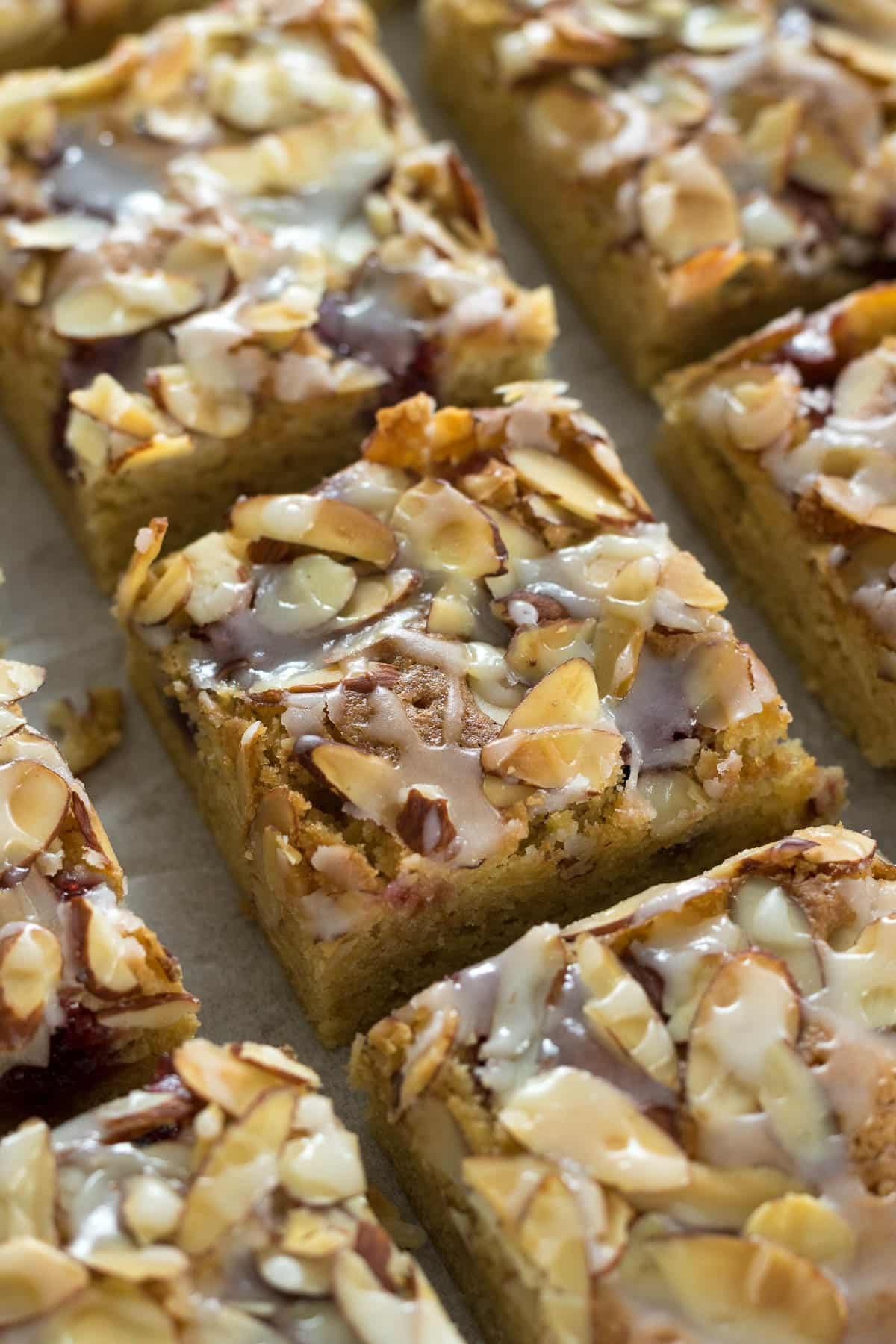 Sliced Bakewell Blondies on a baking paper.